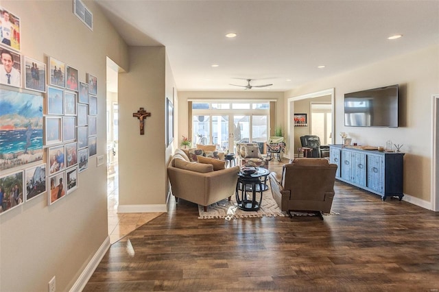 living room with ceiling fan and dark wood-type flooring