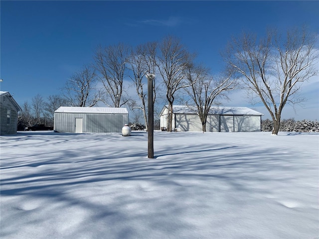 yard covered in snow featuring an outdoor structure