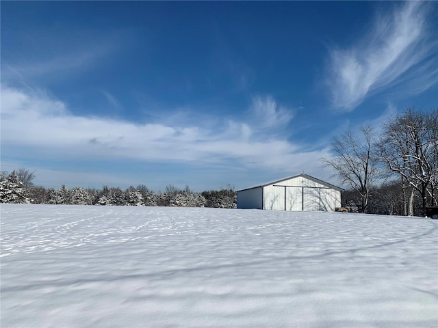 snowy yard with an outbuilding