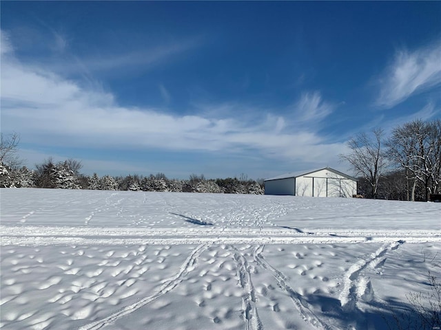 yard covered in snow featuring an outdoor structure