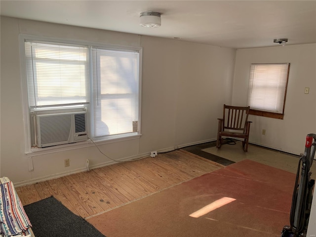 unfurnished room featuring cooling unit and wood-type flooring