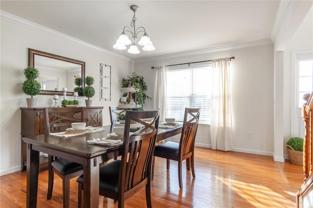 dining space with plenty of natural light, ornamental molding, light hardwood / wood-style floors, and a chandelier