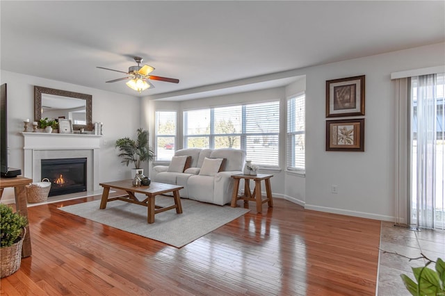 living room featuring hardwood / wood-style flooring, plenty of natural light, and ceiling fan