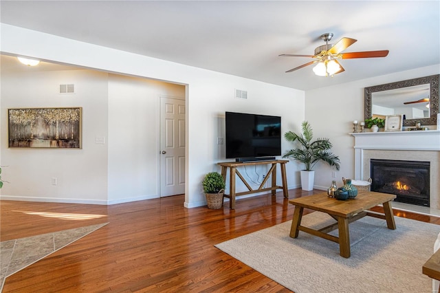 living room featuring hardwood / wood-style floors and ceiling fan