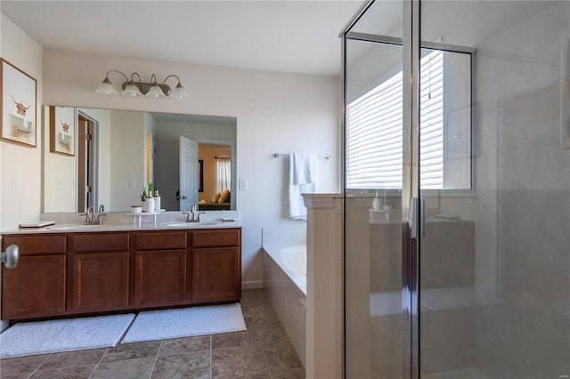 bathroom with vanity and separate shower and tub