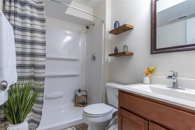 bathroom with vanity, toilet, curtained shower, and tile patterned flooring