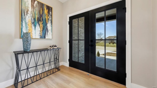 doorway to outside featuring french doors and light wood-type flooring