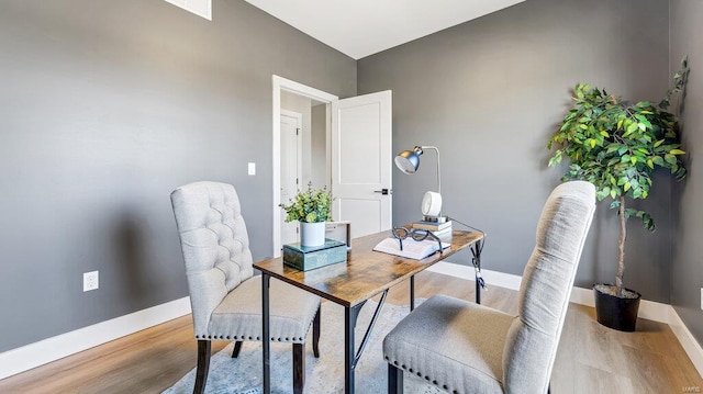 home office with light hardwood / wood-style floors