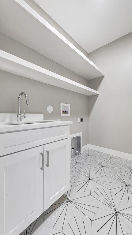 laundry room featuring hookup for an electric dryer, washer hookup, cabinets, and sink