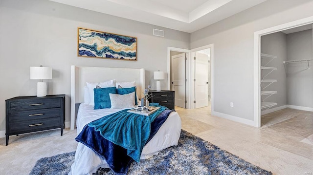 bedroom with a walk in closet and a closet