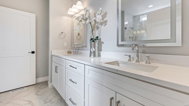 bathroom featuring vanity and a shower with shower door