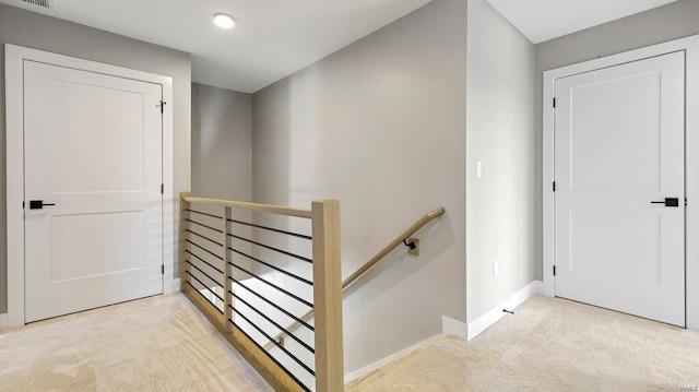 hallway featuring light colored carpet