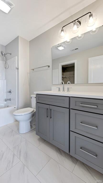 full bathroom with bathtub / shower combination, vanity, and toilet