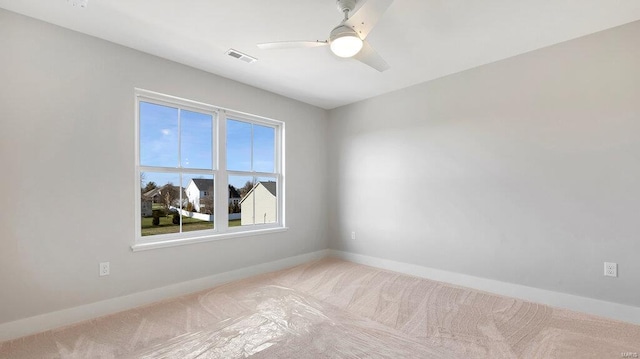 carpeted empty room featuring ceiling fan