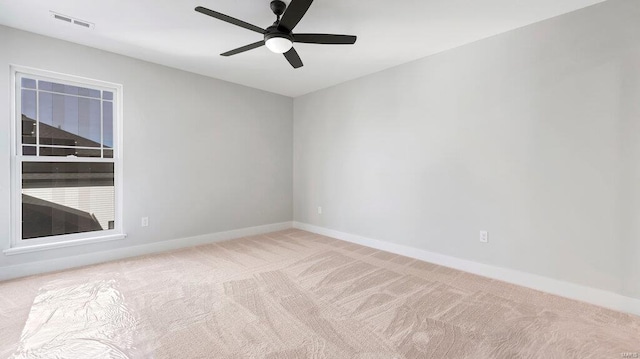 spare room with light carpet and ceiling fan