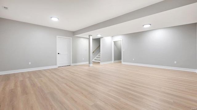 basement with light hardwood / wood-style floors