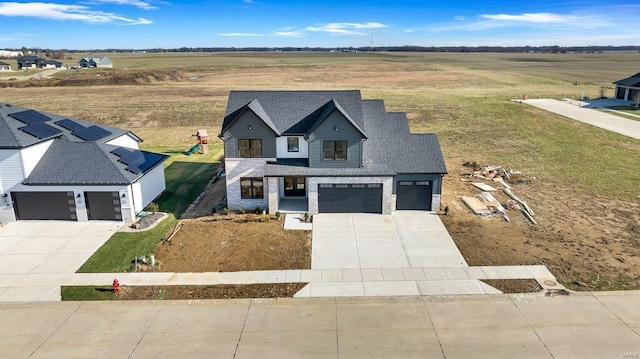 view of front of property featuring a rural view and a garage