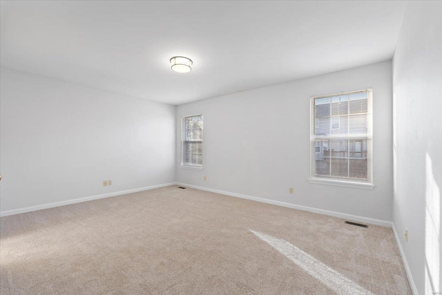 unfurnished room with light carpet