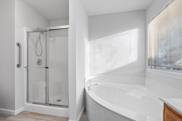 bathroom with vanity, plus walk in shower, and tile patterned flooring