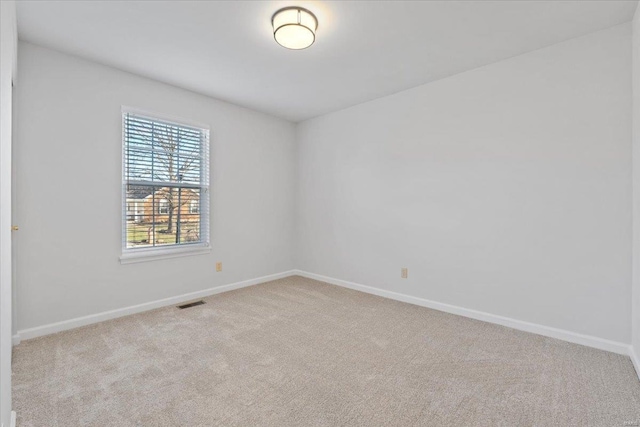 spare room with light colored carpet