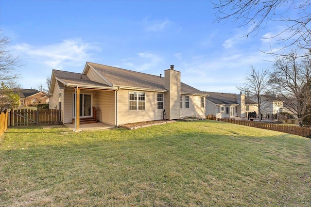 back of house featuring a lawn