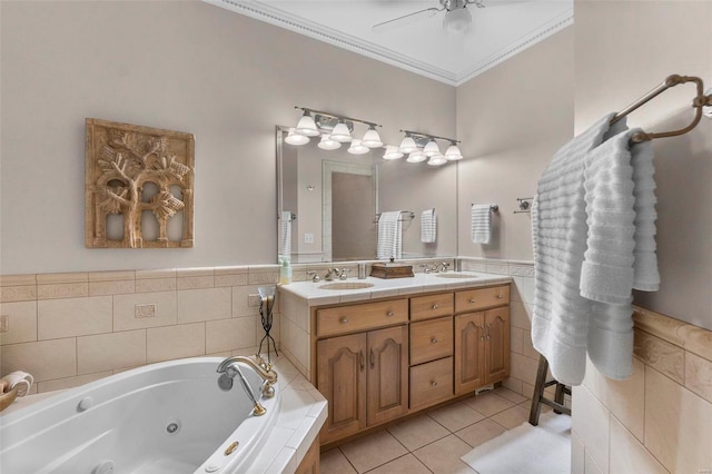 bathroom featuring tile patterned floors, ornamental molding, vanity, ceiling fan, and tiled bath