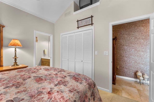 bedroom featuring ensuite bathroom, crown molding, vaulted ceiling, light colored carpet, and a closet