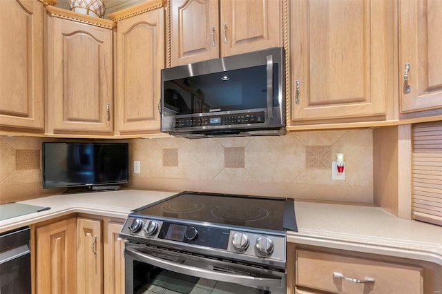 kitchen with light brown cabinets, backsplash, and stainless steel range with electric stovetop