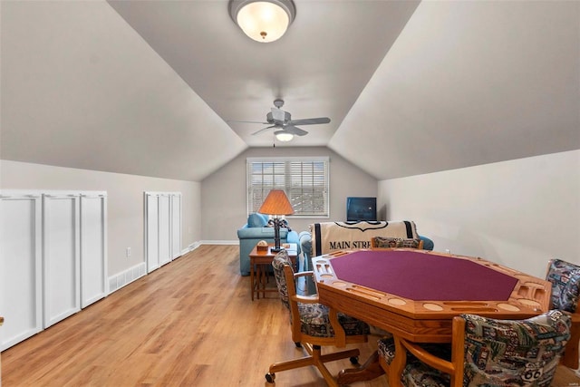 playroom featuring ceiling fan, light hardwood / wood-style floors, and vaulted ceiling