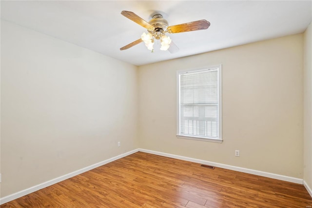 unfurnished room with ceiling fan and wood-type flooring