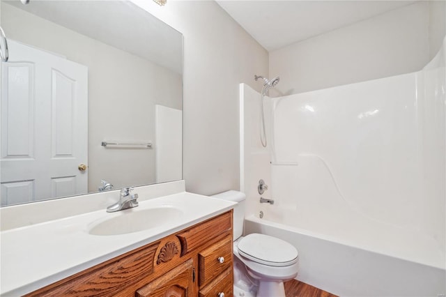 full bathroom featuring toilet, vanity, and shower / washtub combination