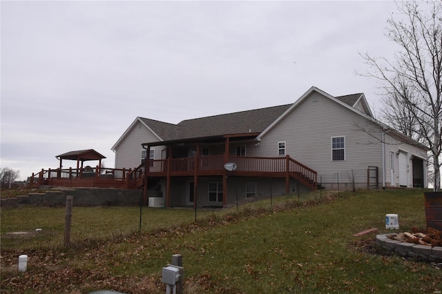 back of house featuring a deck, a gazebo, and a yard