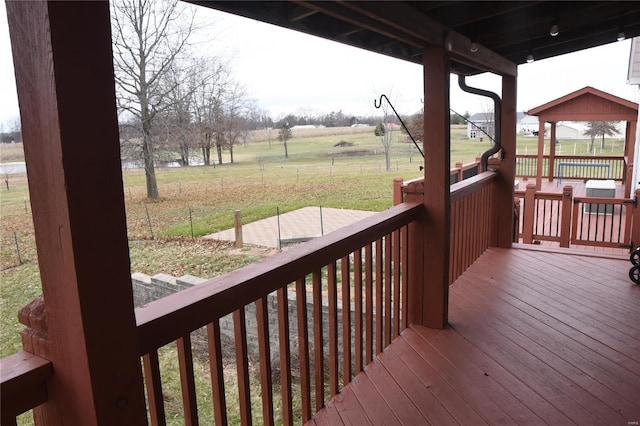 deck with a rural view, a gazebo, and a yard