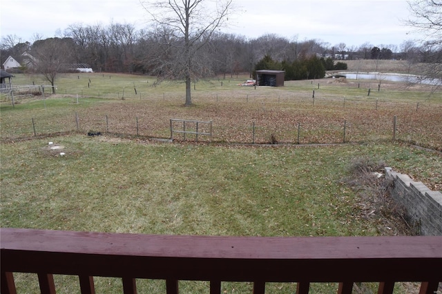 view of yard featuring a storage shed and a rural view