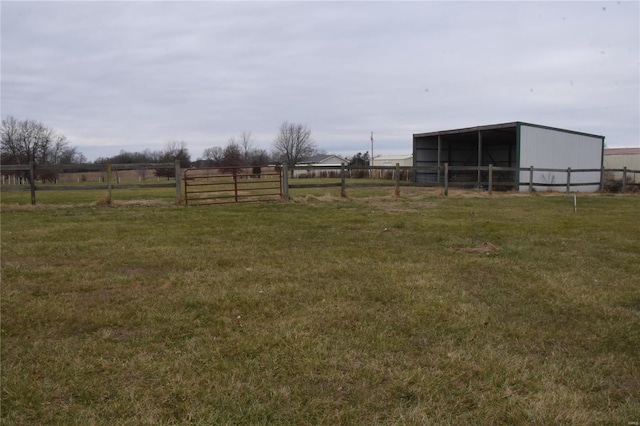 view of yard with an outbuilding and a rural view