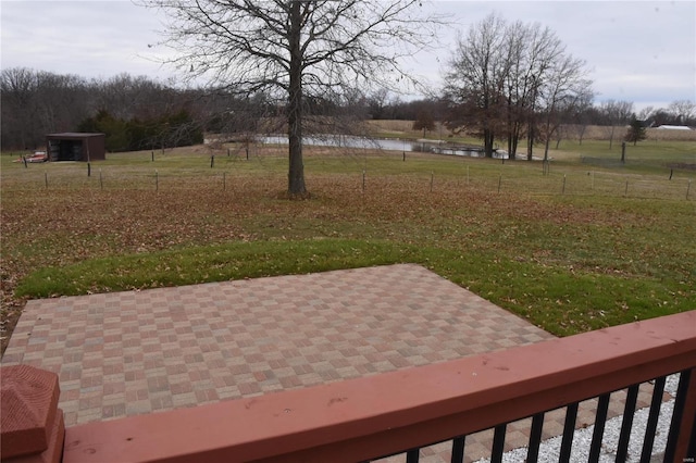 view of yard featuring a water view and a patio