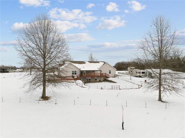 yard layered in snow with a wooden deck