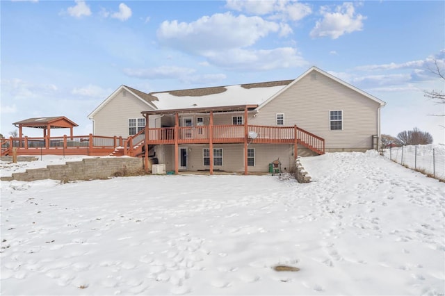 snow covered property with a wooden deck