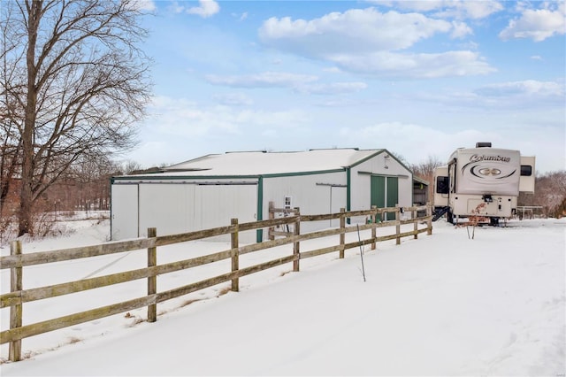 snowy yard featuring an outbuilding