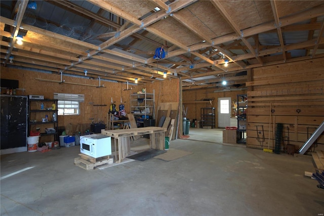 garage featuring a workshop area and wood walls