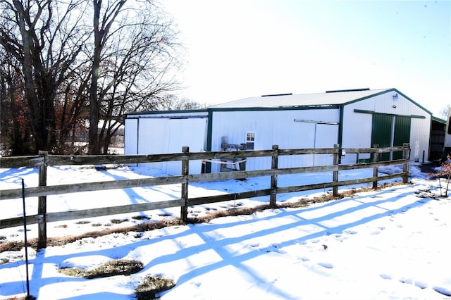 yard layered in snow with an outdoor structure