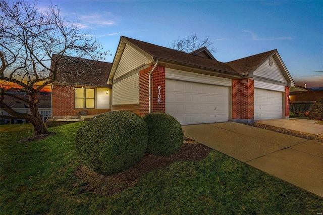 view of front of property with a lawn and a garage