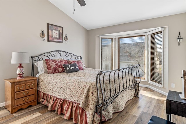 bedroom with lofted ceiling, ceiling fan, and hardwood / wood-style floors