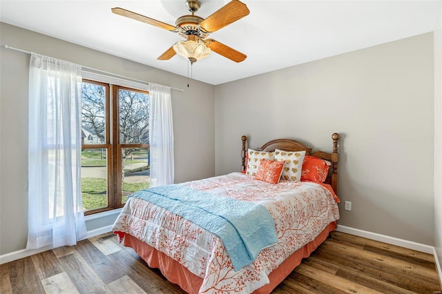 bedroom featuring dark hardwood / wood-style flooring and ceiling fan