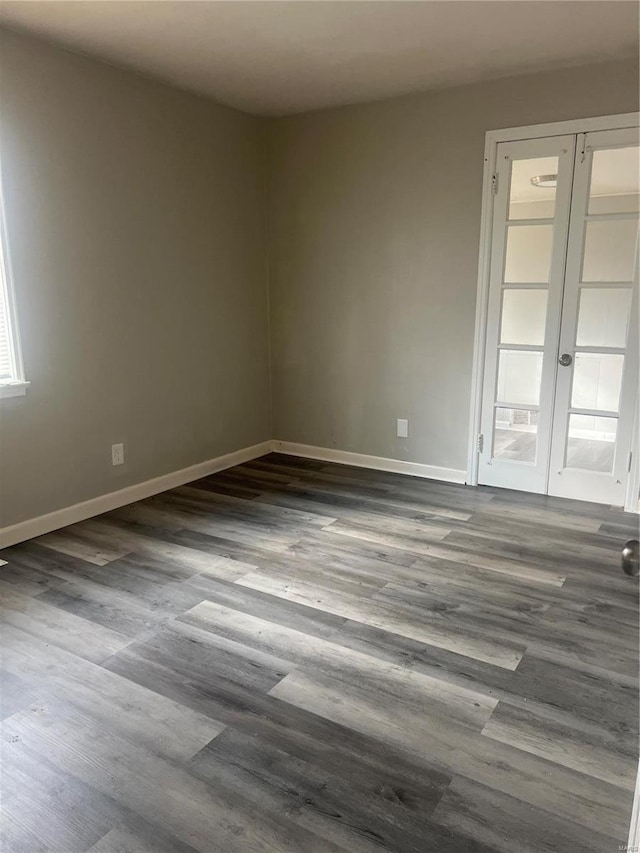 spare room with french doors and dark wood-type flooring