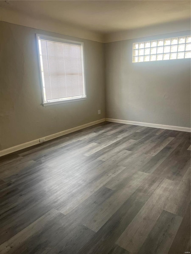 spare room featuring dark wood-type flooring