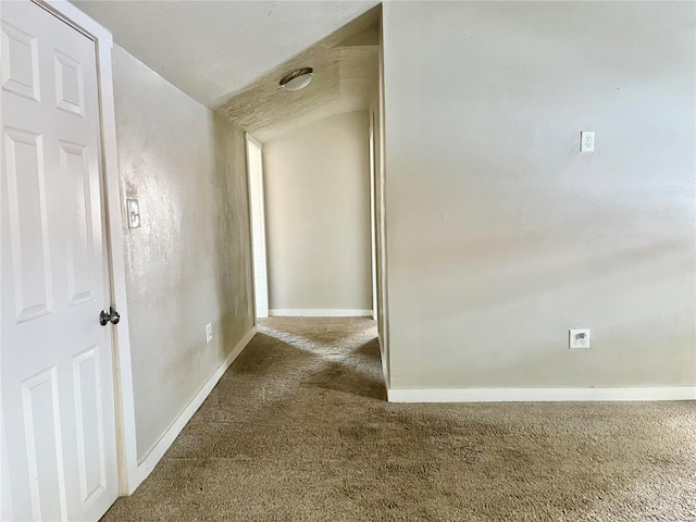 hall featuring carpet and lofted ceiling