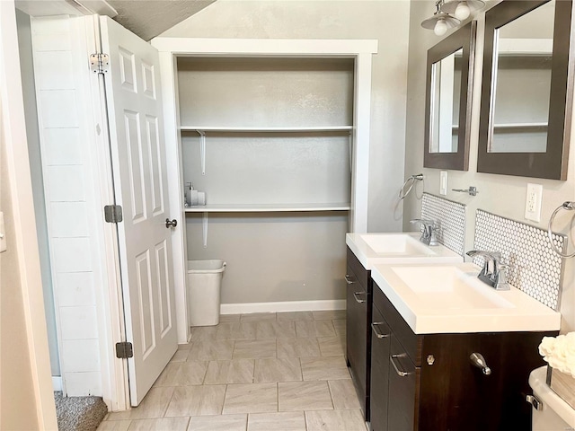 bathroom featuring vanity and backsplash