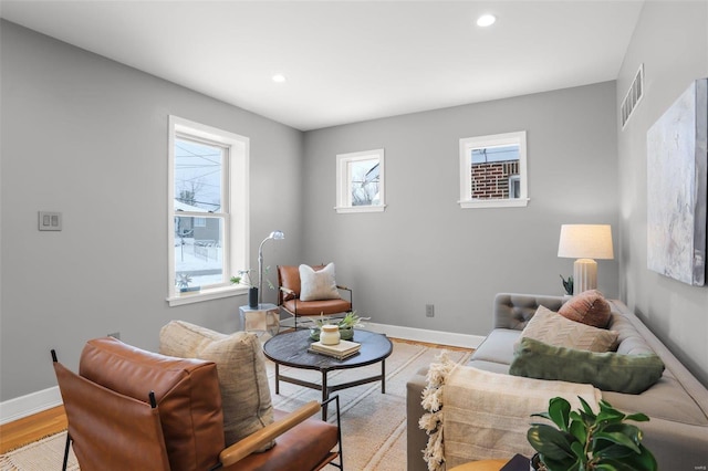 living room with light hardwood / wood-style floors and a healthy amount of sunlight