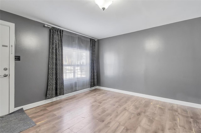 spare room with light hardwood / wood-style flooring